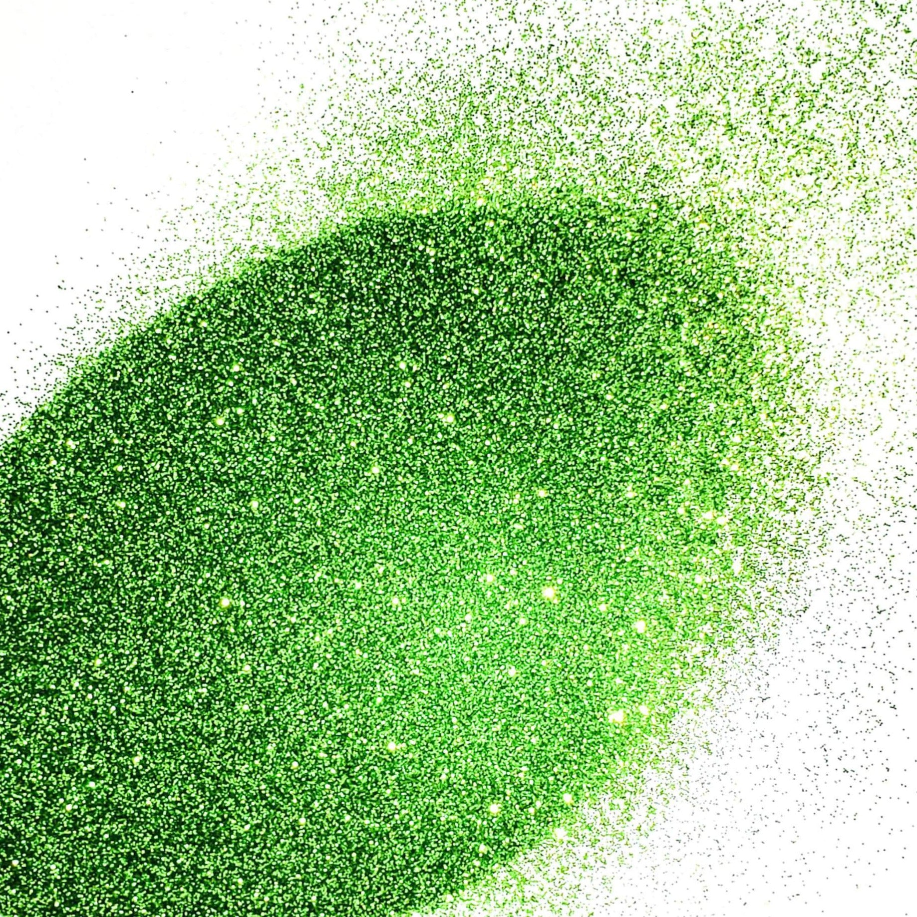 A pile of extra fine green glitter with a metallic finish