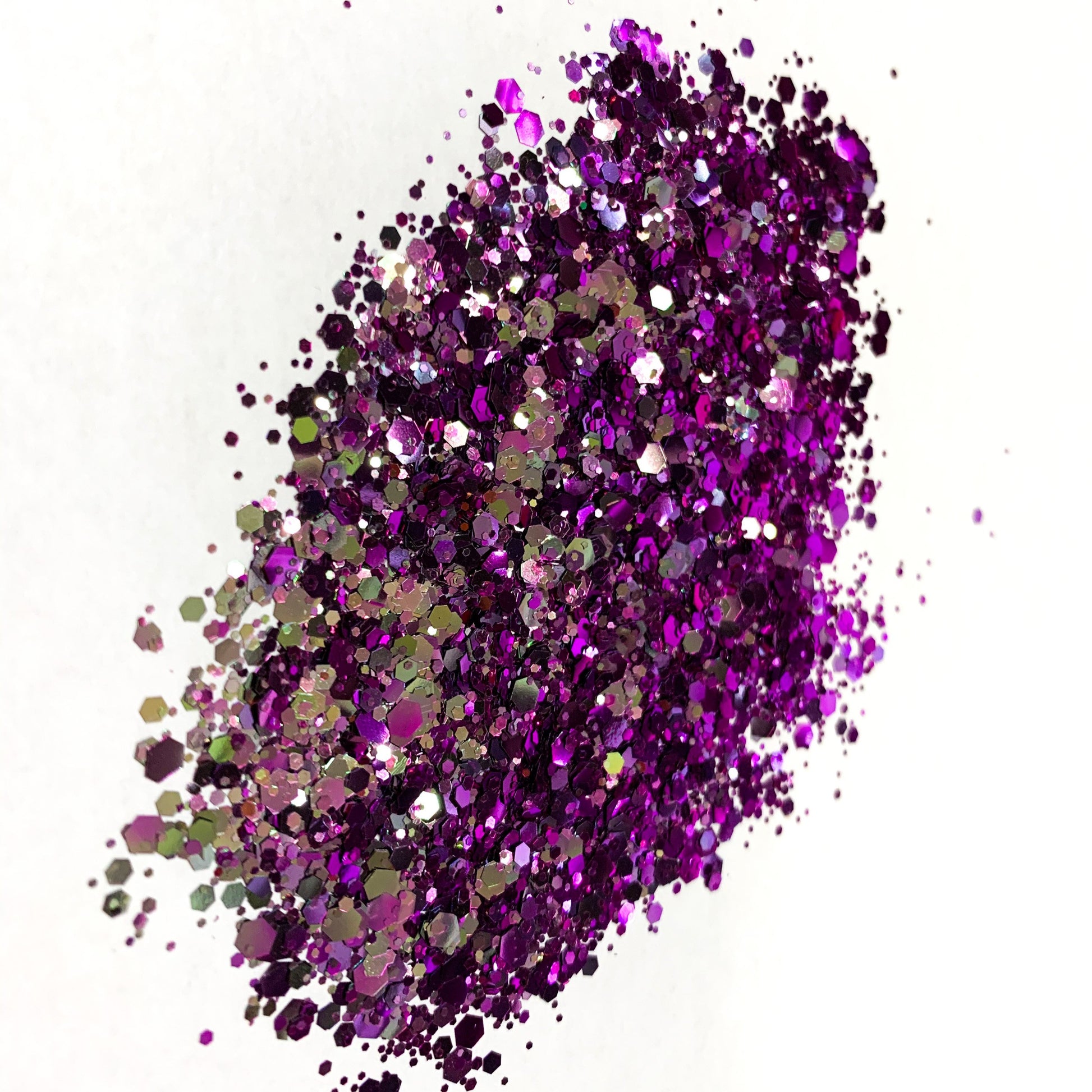 A silver/purple chameleon colour shift glitter on a white background.