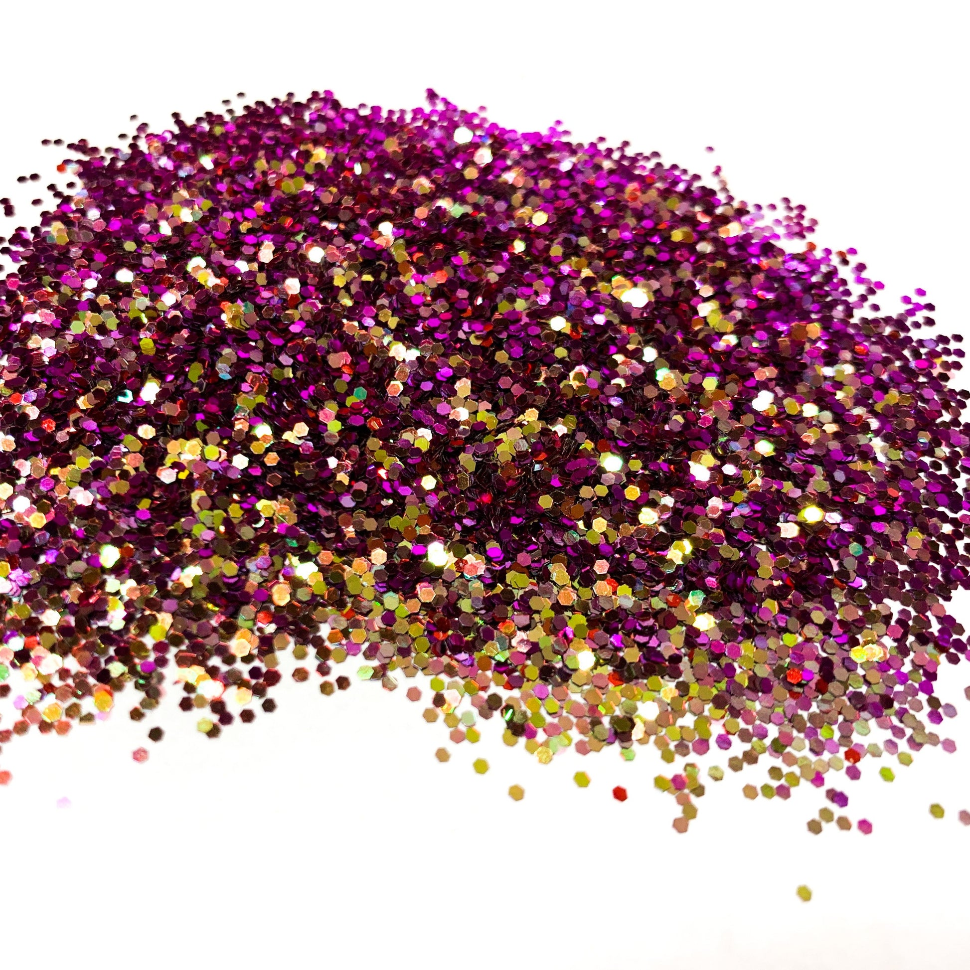A purple/gold chameleon colour shift glitter on a white background.