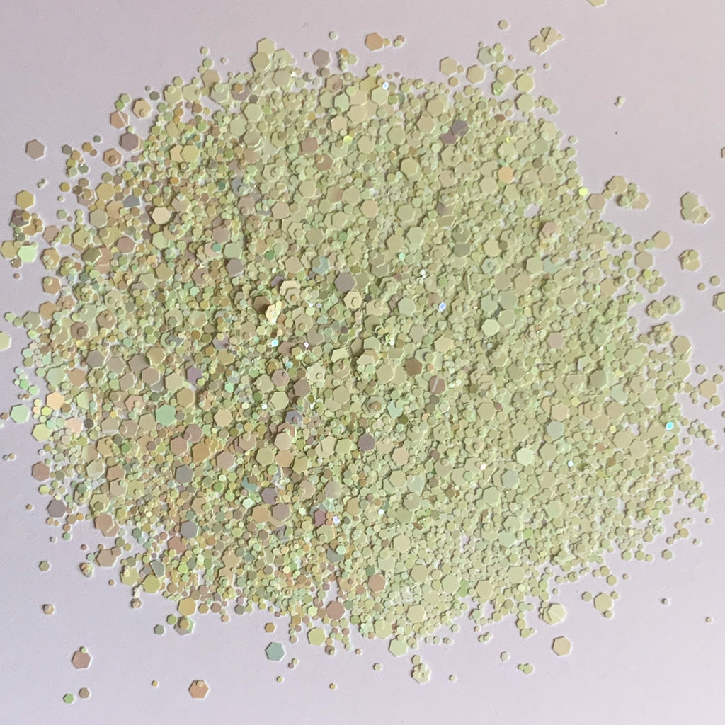 A pile of light green rainbow gradient chunky glitter mix.