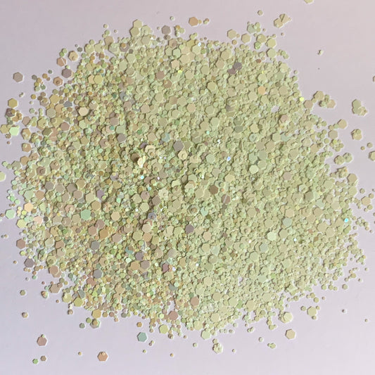 A pile of light green rainbow gradient chunky glitter mix.