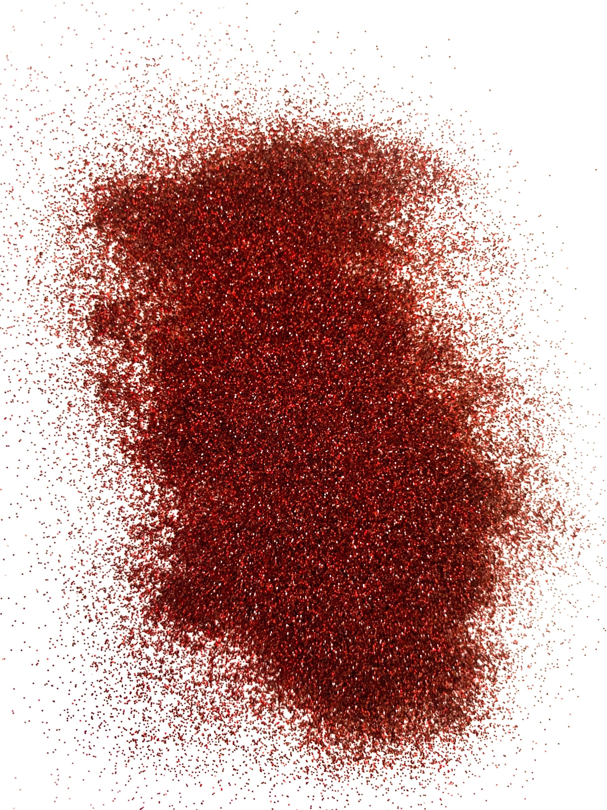 A pile of extra fine maroon glitter on a white background.