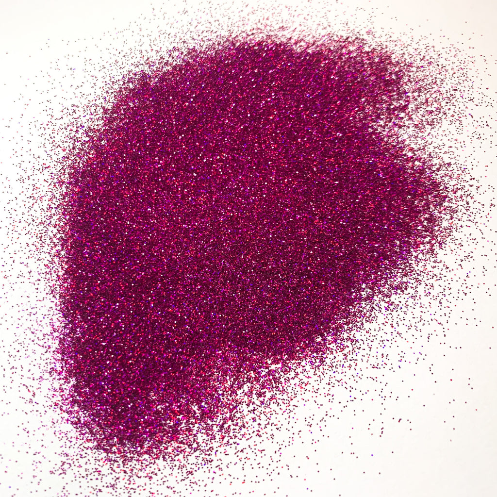 A pile of purple glitter on a white background.