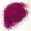 A pile of purple glitter on a white background.