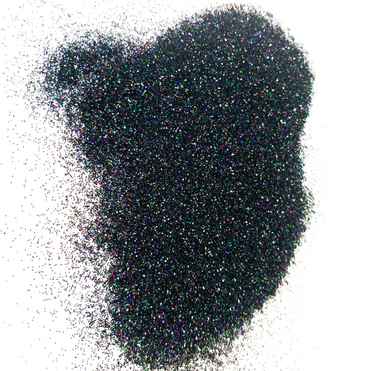 A pile of dark glitter on a white background.
