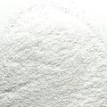 A close-up image of extra fine white glitter distributed on a surface, resembling the texture of icing sugar with sparkles.
