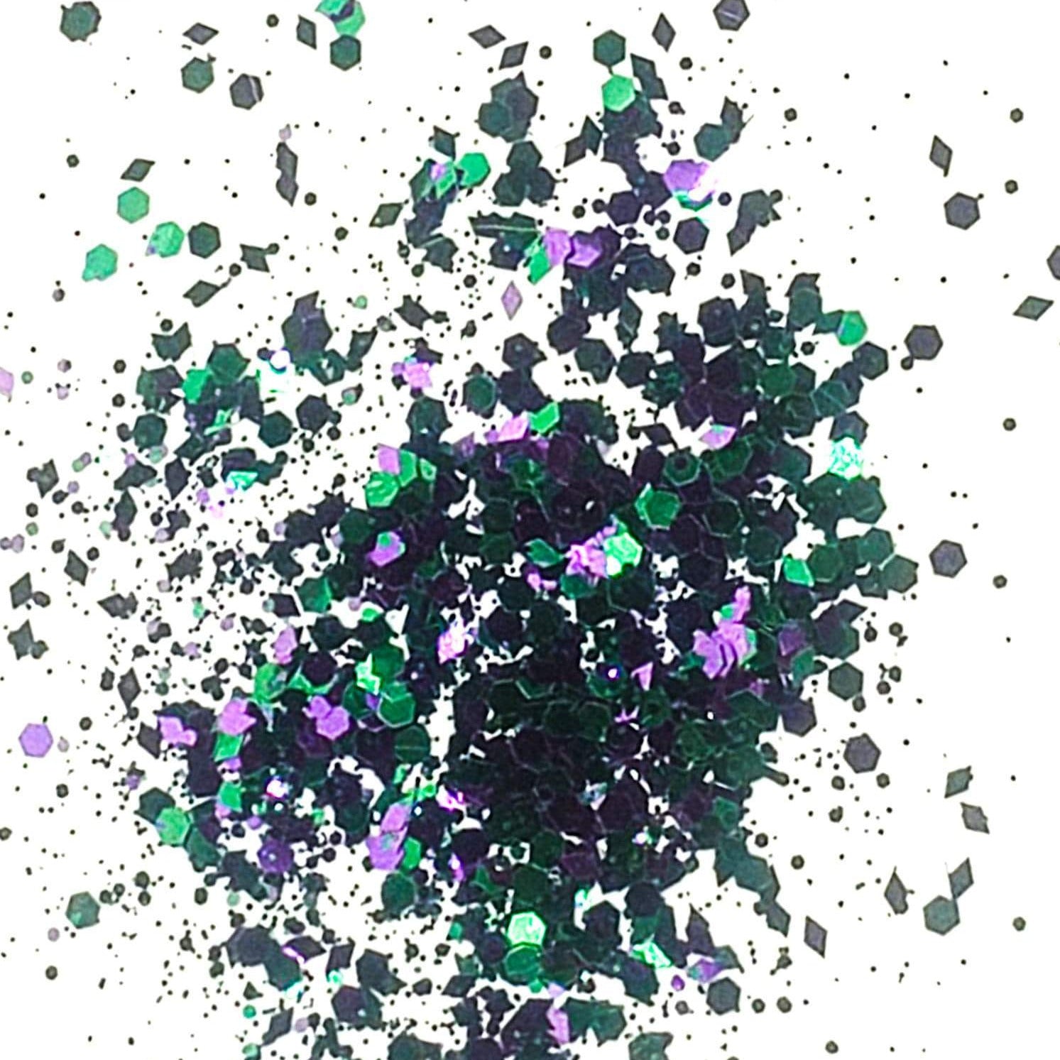 A mixture of green and purple chunky glitter, scattered on a white background.