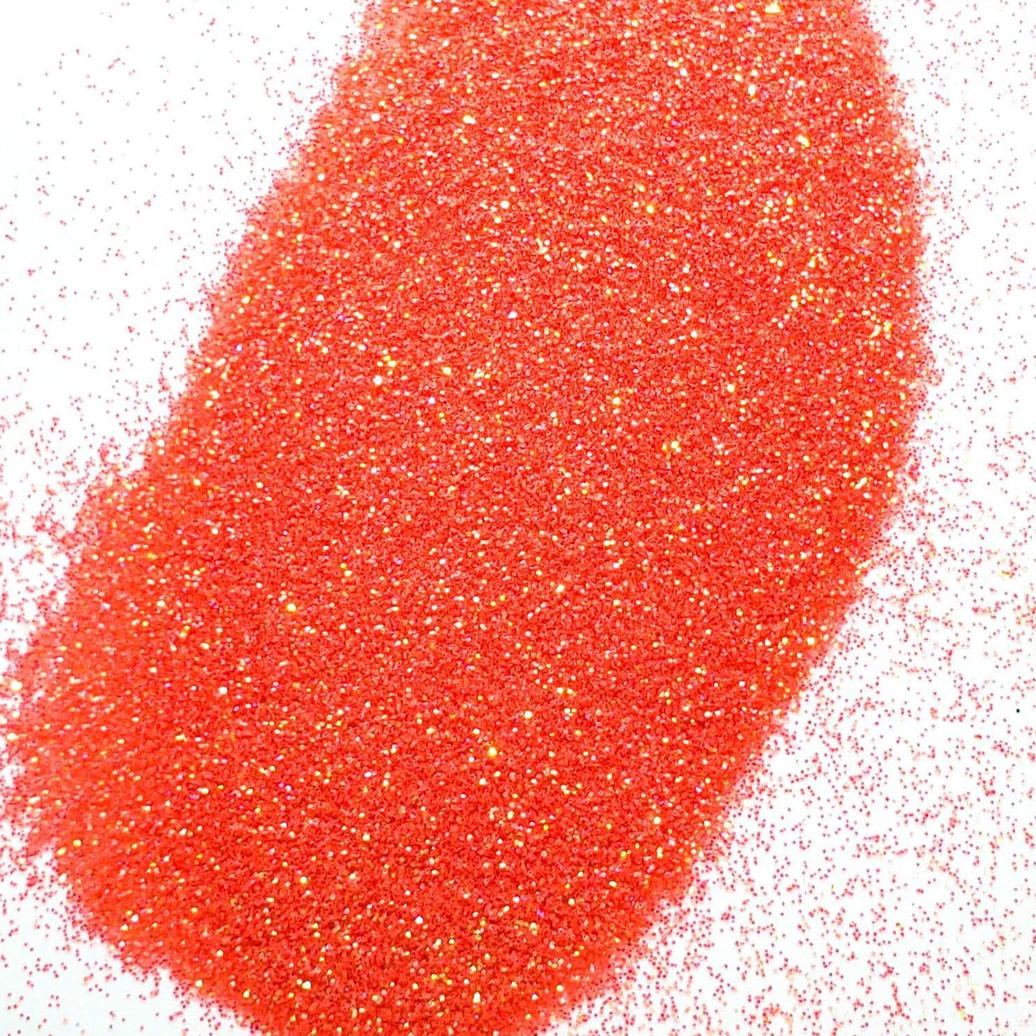 A pile of pink glitter, in extra fine on a white background.