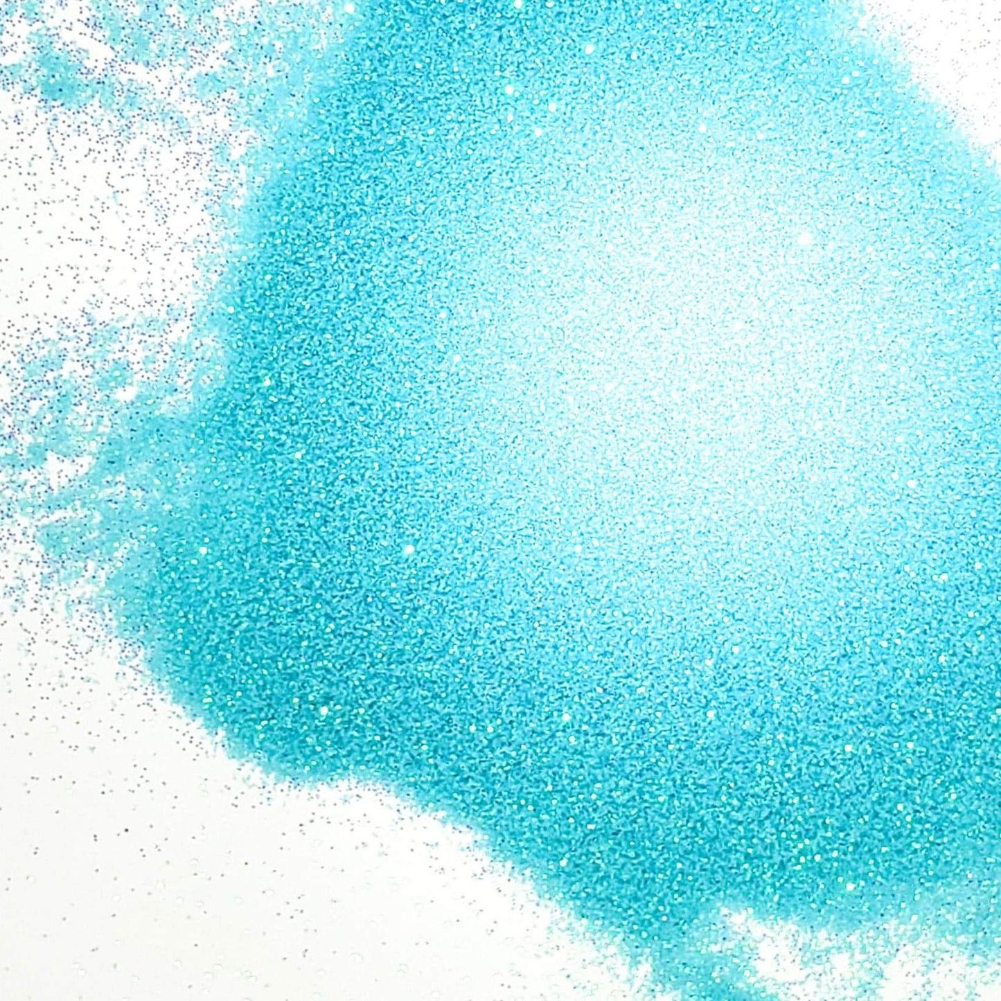 A close-up image of blue iridescent glitter spread on a surface.