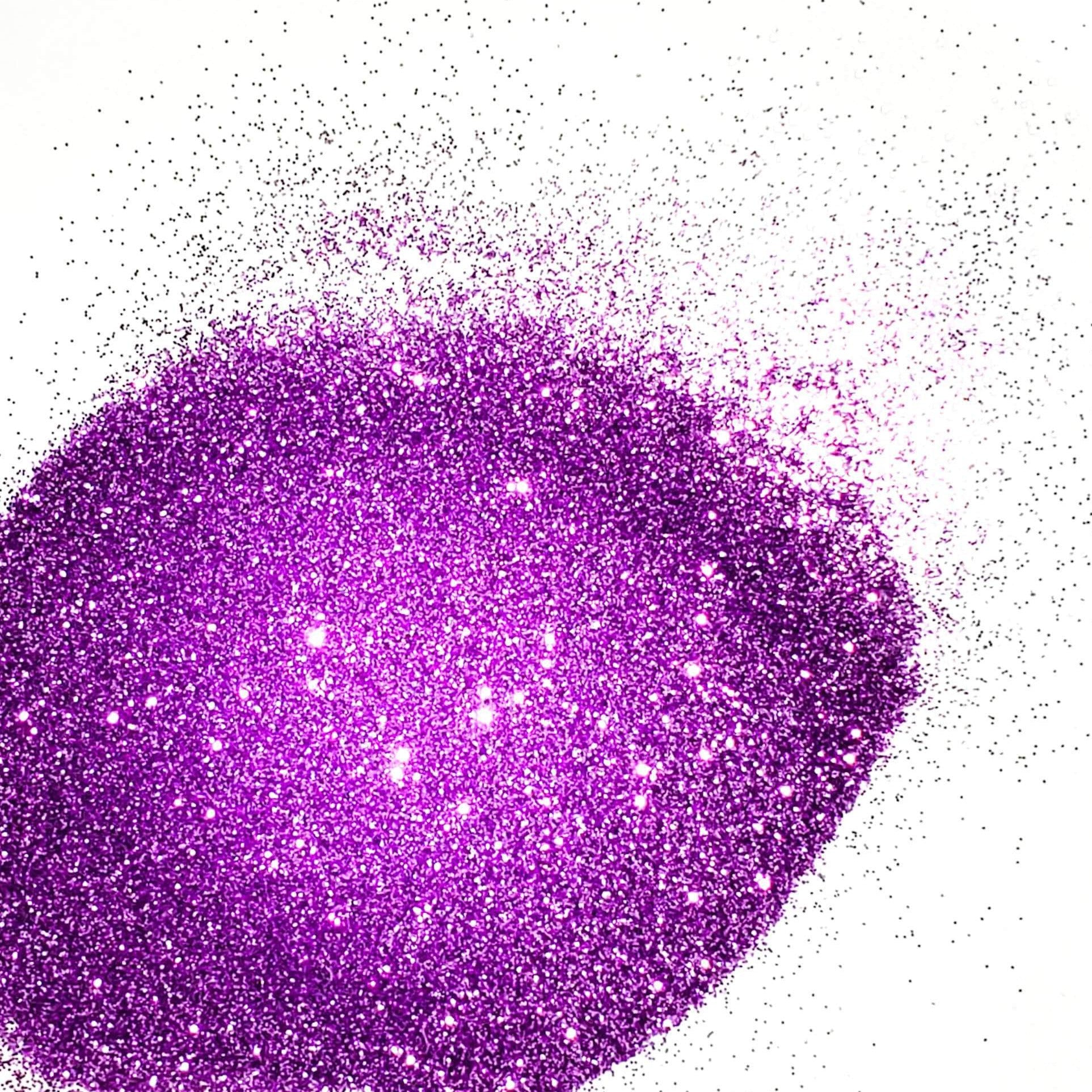 A close-up image of lilac purple colored polyester glitter spread on a surface.