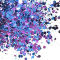 A close-up image of blue and pink chunky glitter spread out on a surface.