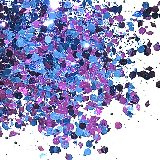A close-up image of blue and pink chunky glitter spread out on a surface.