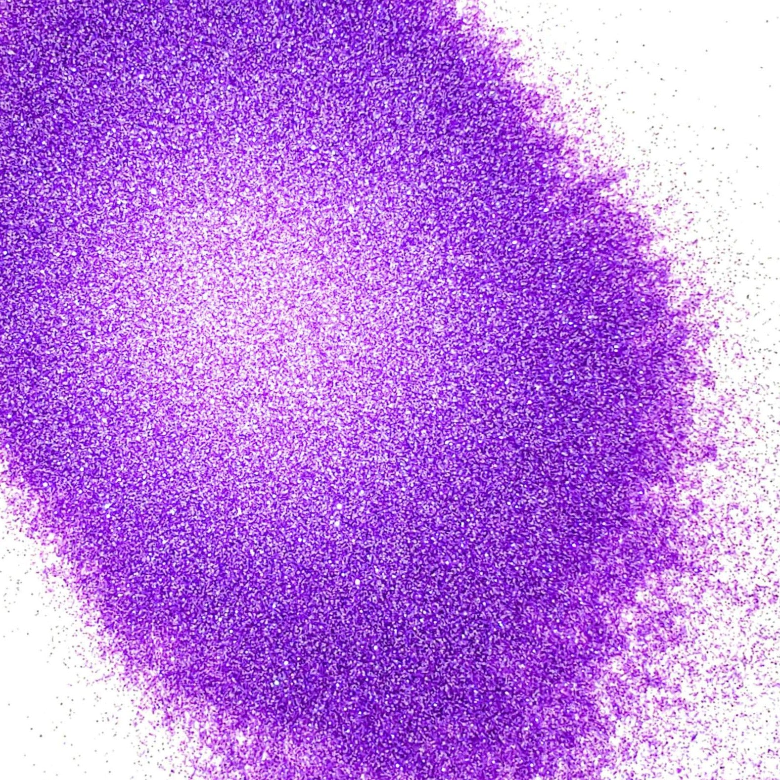 A pile of purple glitter, in extra fine on a white background.