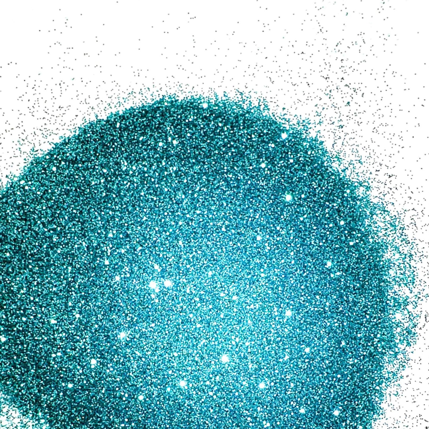 A pile of blue metallic glitter, spread out on a white background.