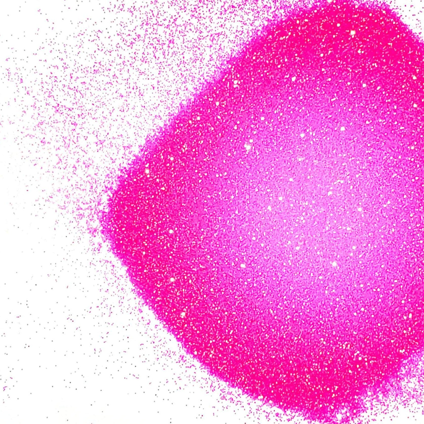 A pile of pink glitter, in extra fine on a white background.