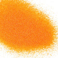 A pile of orange colored polyester glitter with a matte finish.