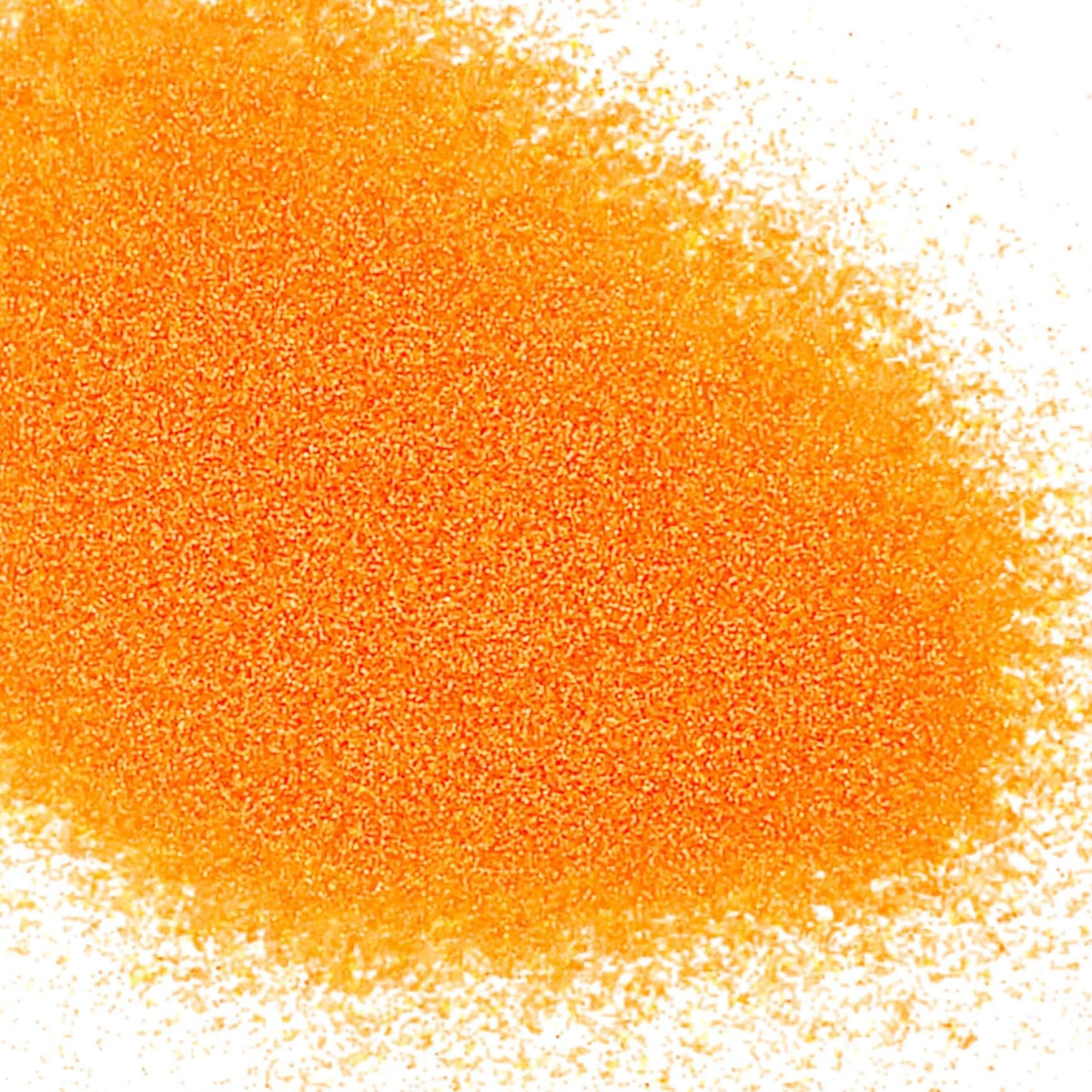 A pile of orange colored polyester glitter with a matte finish.