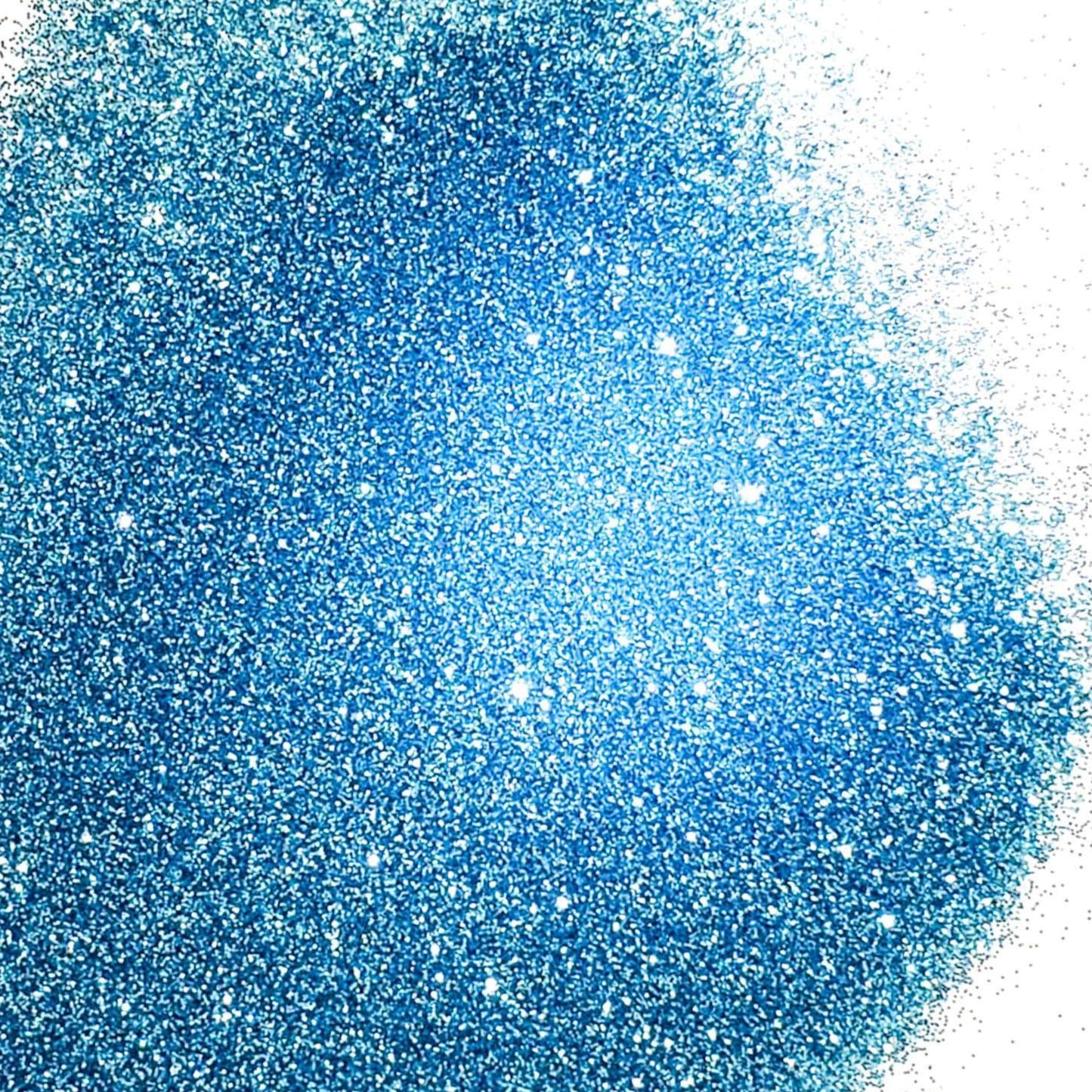 A pile of light blue glitter, in extra fine on a white background.