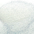 A close-up image of white iridescent glitter, showing the fine particles and reflective surfaces.