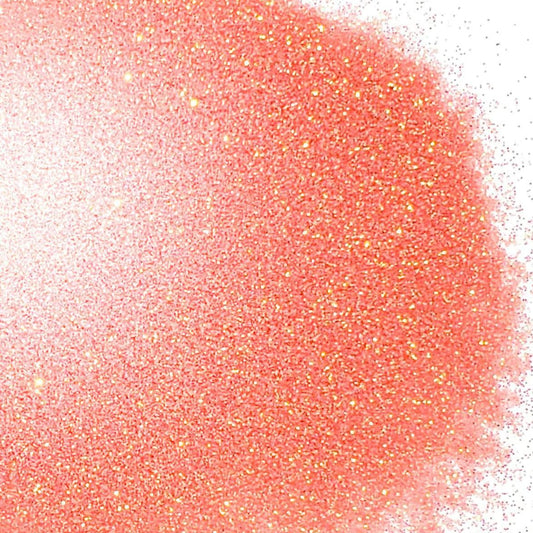 A close-up image of peach-colored iridescent glitter spread on a surface.