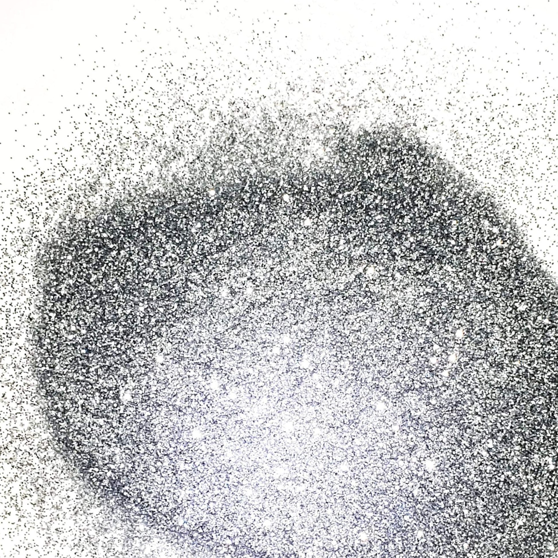 A close-up image of extra fine silver glitter spread out on a surface.