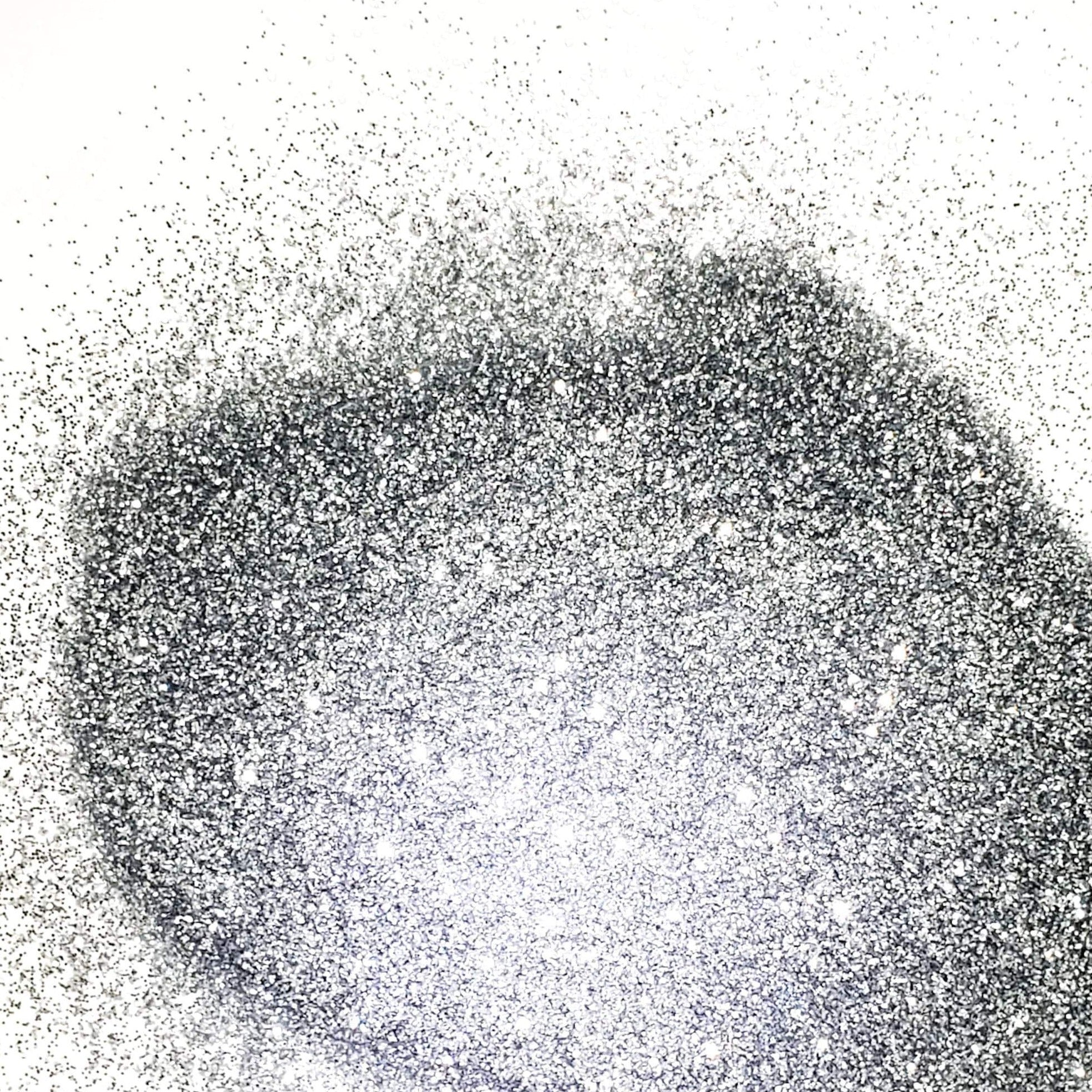 A close-up image of extra fine silver glitter spread out on a surface.