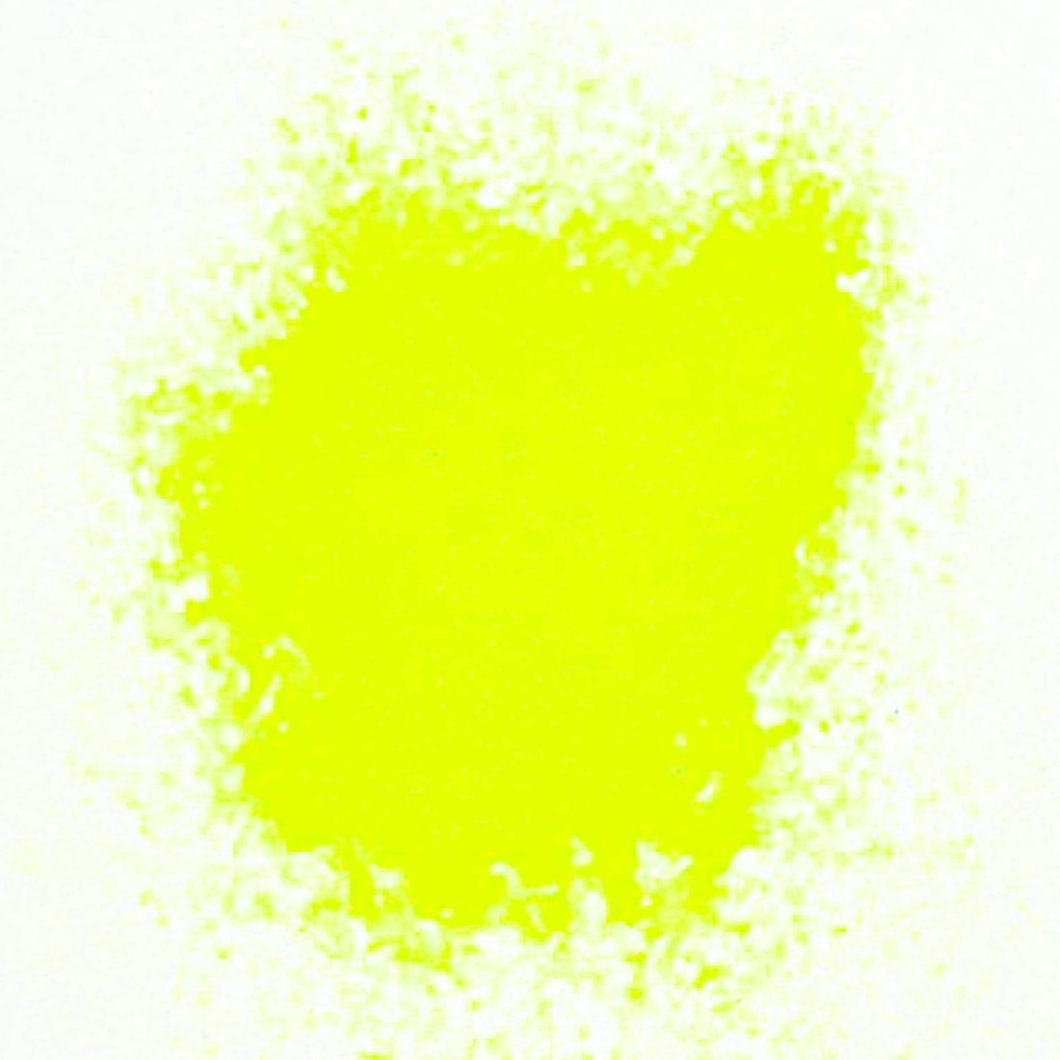 A close-up image of yellow fluorescent matte glitter spread out on a white surface.