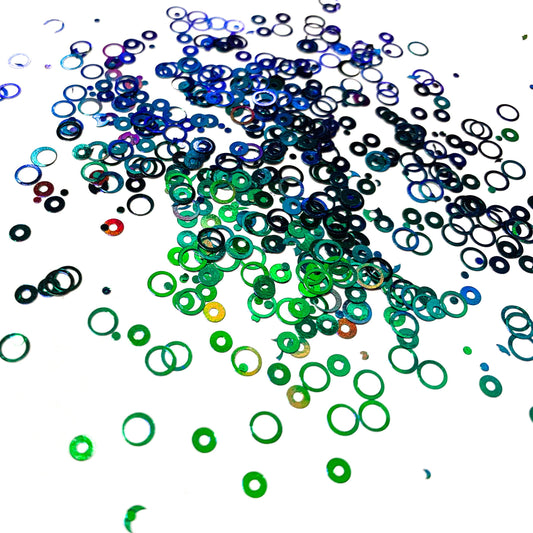 A green/blue chameleon colour shift hollow circle glitter on a white background.