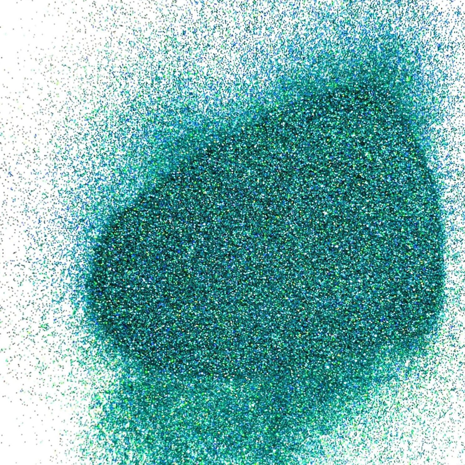 A pile of turquoise holographic glitter, in extra fine on a white background.