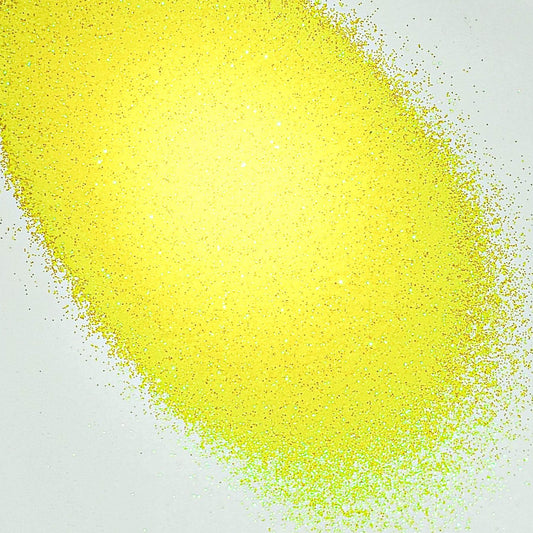 A pile of yellow glitter, in extra fine on a white background.