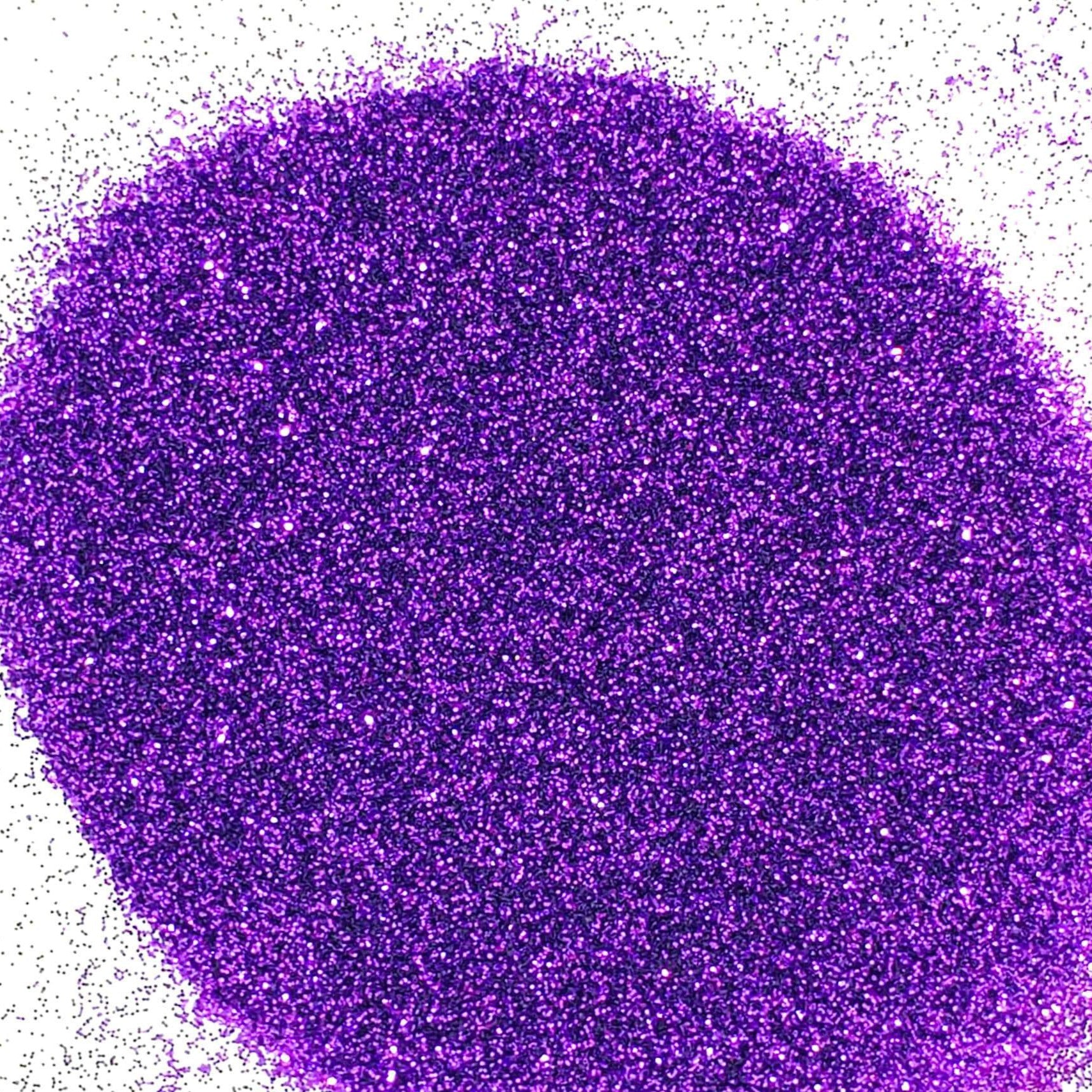 A close-up image of deep purple extra fine glitter spread on a white background