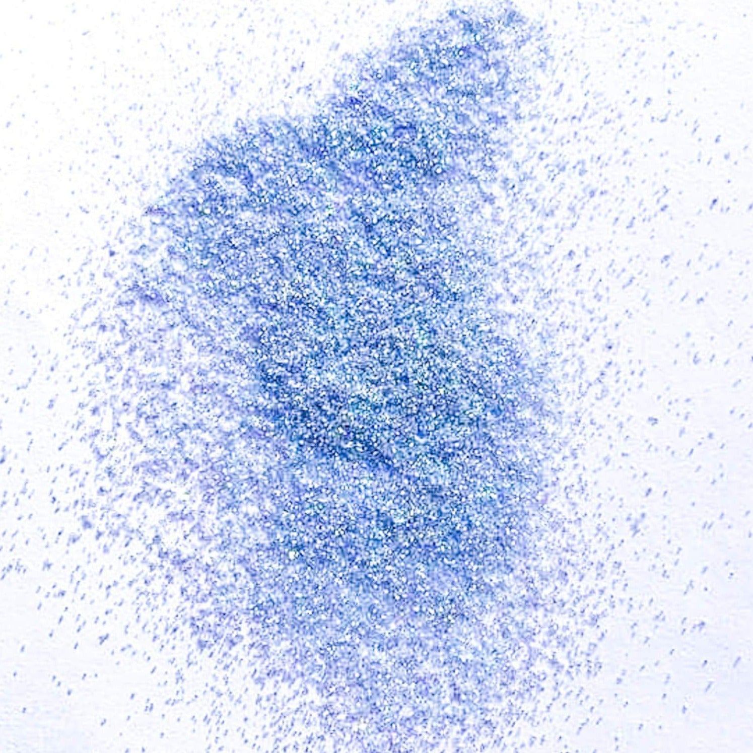 A pile of blue polyester glitter spread on a white background.